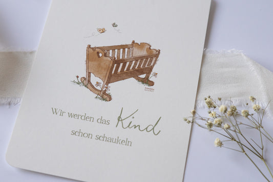 Postkarte mit handgezeichneter Babywiege und dem Spruch „Wir werden das Kind schon schaukeln“ – liebevolle Karte zur Geburt oder Taufe.