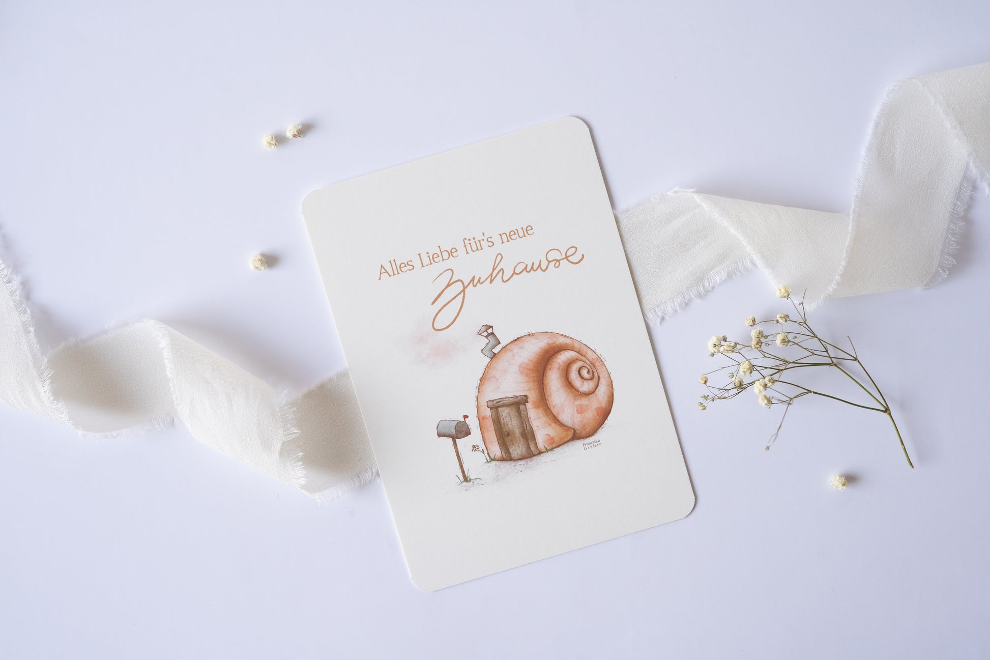Postkarte mit Illustration eines Schneckenhauses und dem Text „Alles Liebe fürs neue Zuhause“ – Grußkarte zum Einzug oder Umzug